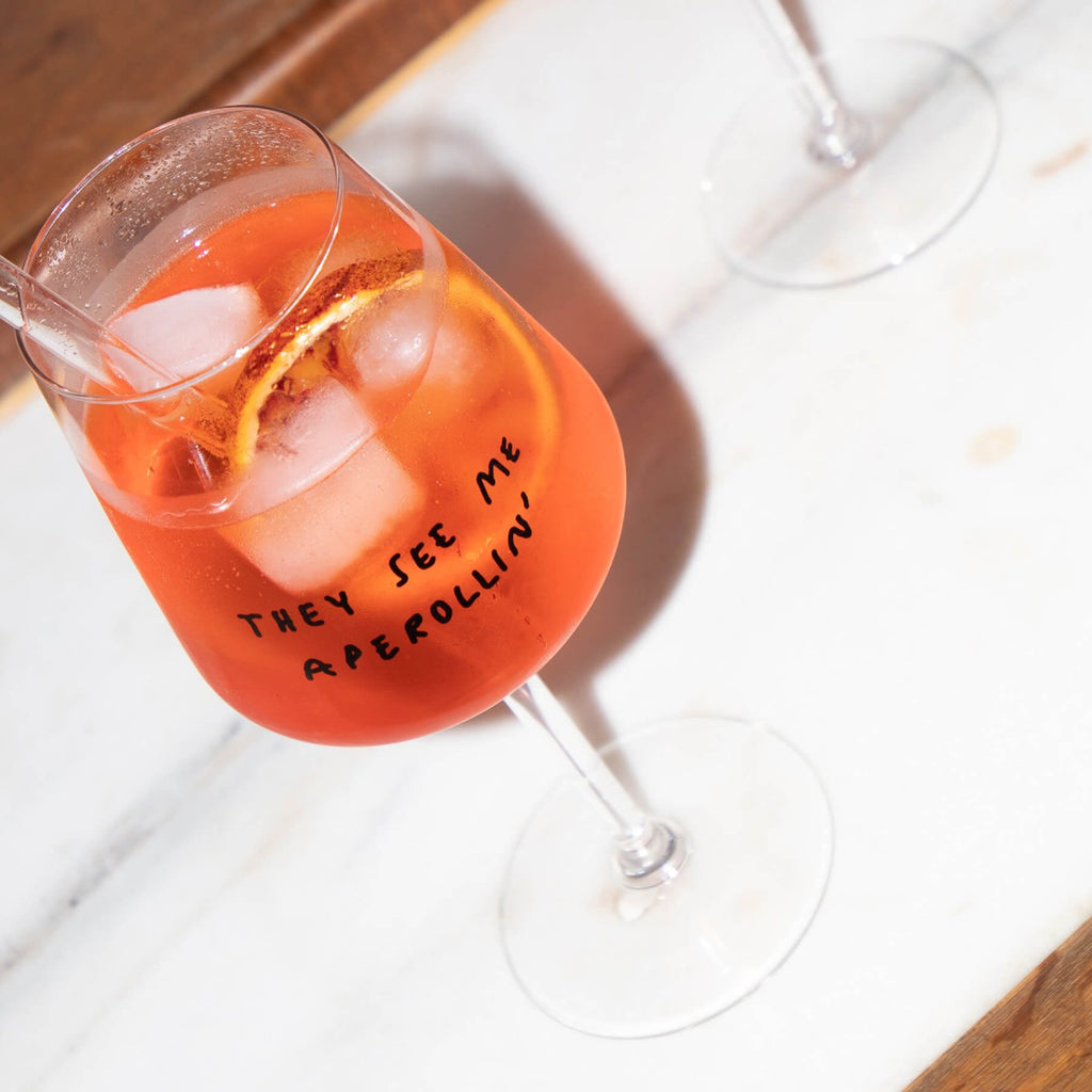"They See Me Aperolin'" Wine Glass by Johanna Schwarzer × Selekkt